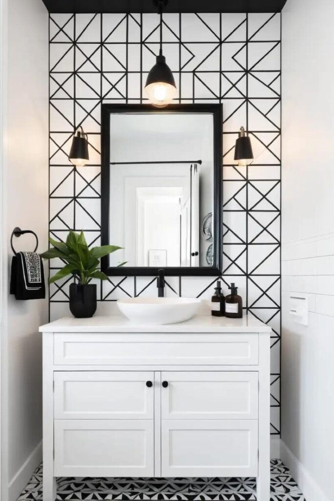 A black and white bathroom with a monochrome patterned wallpaper accent wall.