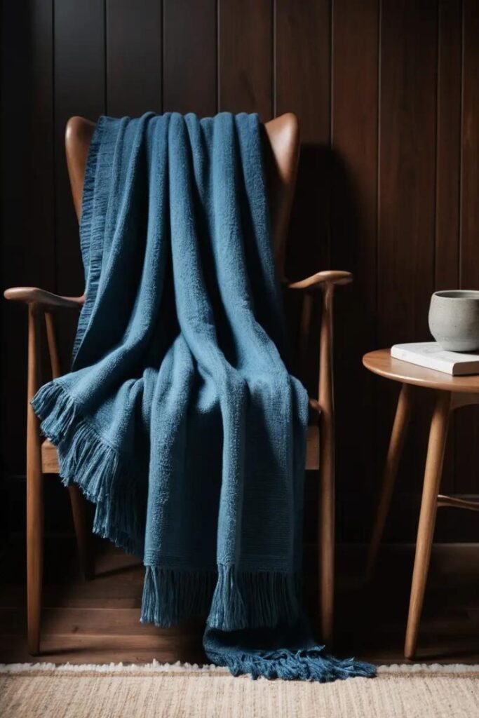 A stylish living room with dark brown paneling and blue accents for contrast.