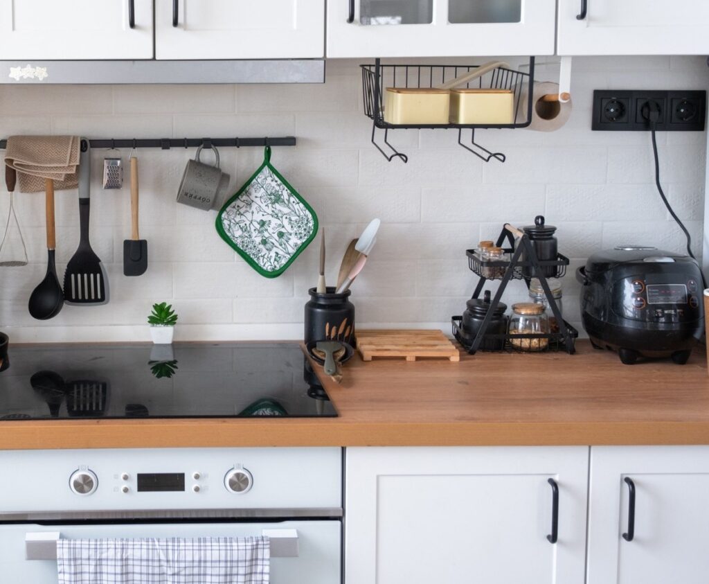 Light white modern rustic kitchen decorated with potted plants, loft-style kitchen utensils. Interior of a house with homeplants