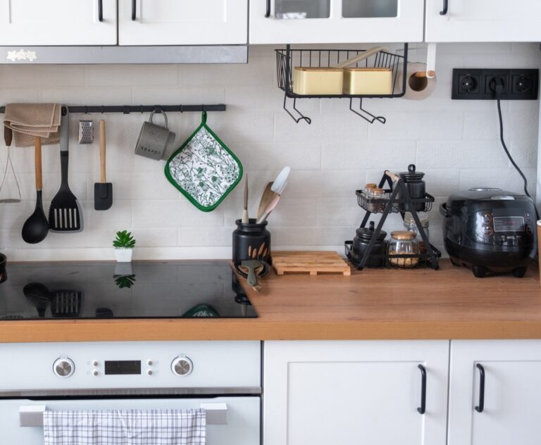 Light white modern rustic kitchen decorated with potted plants, loft-style kitchen utensils. Interior of a house with homeplants