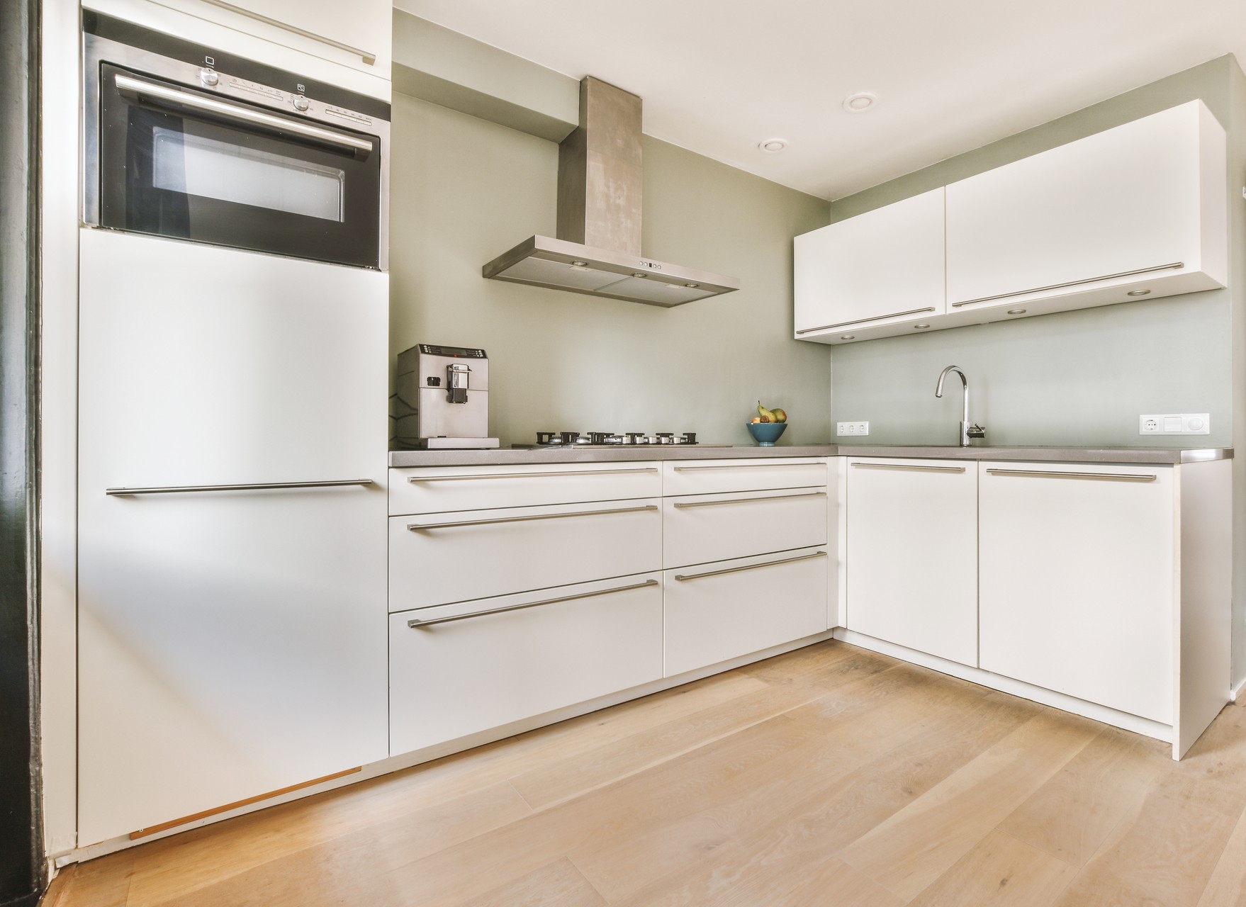 Counters with stove and oven located in modern kitchen near dining room at home