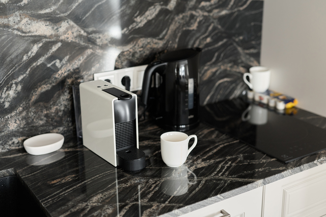A Stylish Modern Kitchen Counter Featuring Sleek Coffee Machines and Elegant Cups