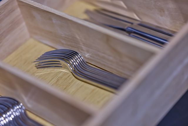 Neatly Arranged Stainless Steel Forks in Wooden Tray