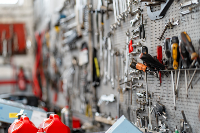 Various hand tools organized on pegboard in workshop
